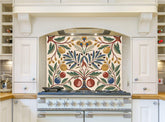 May include: A white kitchen with a range hood and a range with a decorative tile backsplash featuring a stylized floral design with yellow, red, blue, and green leaves and fruit. The backsplash is cream colored with a white border.