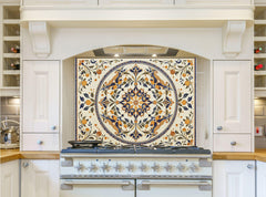 May include: A white kitchen with a white range hood and a white range with six burner knobs. The backsplash is a cream colored tile with a blue and gold floral design.