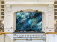 May include: A white kitchen with a stainless steel range hood and a blue and green abstract art glass backsplash. The range hood has a light fixture and the range has six burners and two ovens.