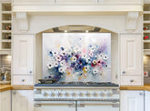 May include: A white kitchen range with a floral backsplash. The backsplash is a painting of white, pink, purple, and blue flowers on a white background. The range has six burner knobs and a large oven door.