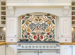 May include: A white kitchen with a range hood and a range with a decorative tile backsplash featuring a stylized floral design with yellow, red, blue, and green leaves and fruit. The backsplash is cream colored with a white border.