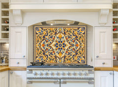 May include: A white kitchen with a stainless steel range hood and a stovetop. The range hood has a decorative tile backsplash with a floral pattern in shades of blue, yellow, and orange.