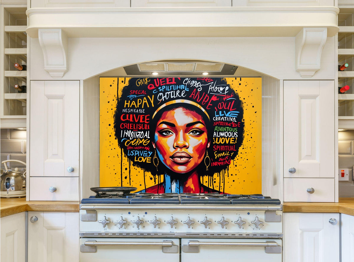May include: A white kitchen with a black and yellow stove and a colorful art piece above the stove. The art piece features a portrait of a woman with a colorful afro and words like 'Queen', 'Happy', 'Love', 'Soul', and 'Spiritual' written around her.