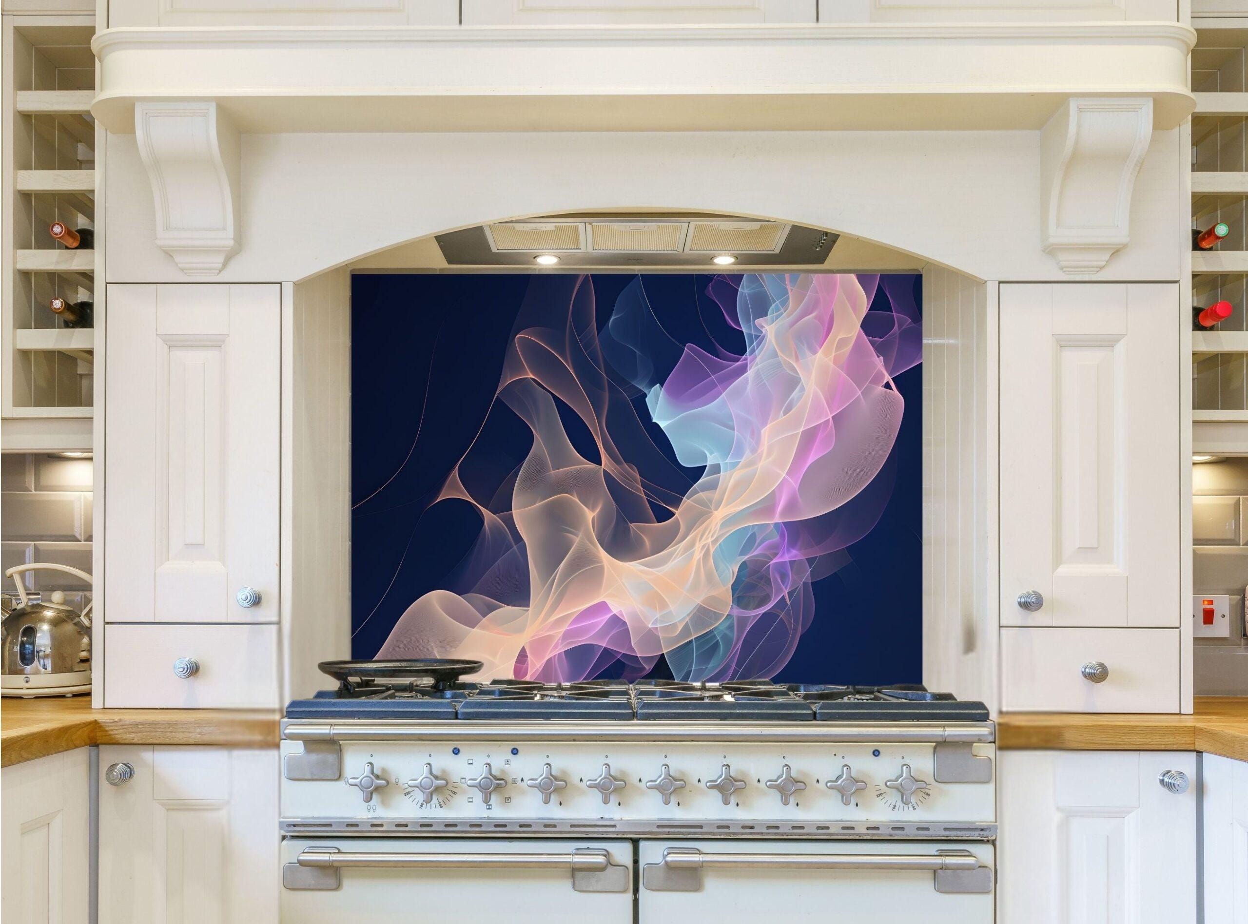 May include: A kitchen with a white range hood and white cabinets. The backsplash behind the stove is a dark blue with a colorful abstract design of pink, blue, and yellow swirls.
