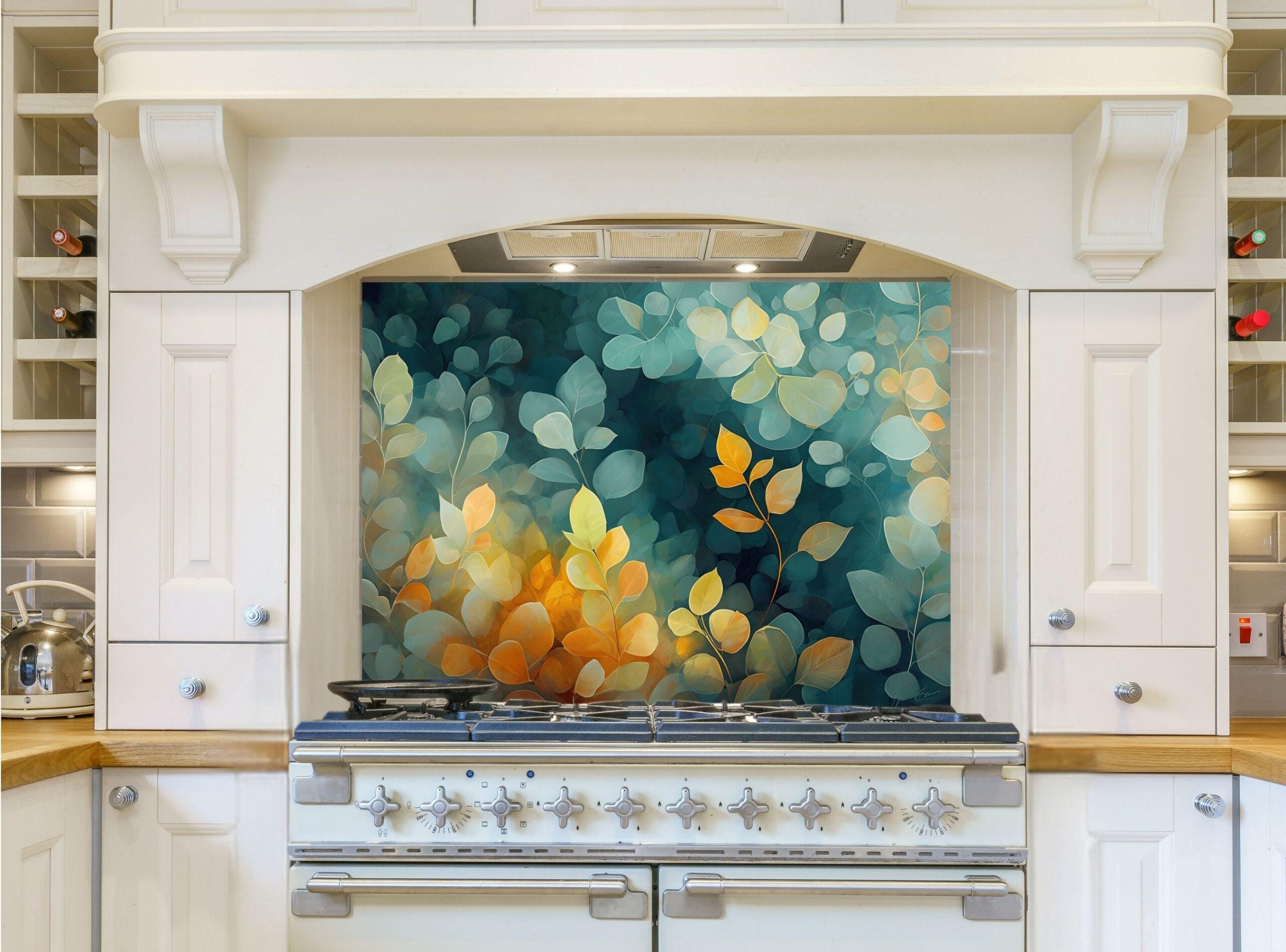 May include: A white kitchen with a range hood and a stainless steel range. The backsplash behind the range is a teal and yellow floral design. The kitchen cabinets are white with silver hardware.