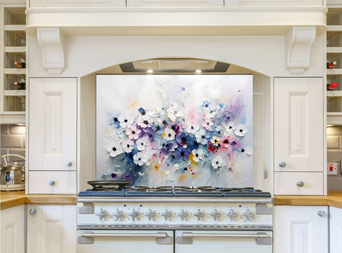 May include: A white kitchen range with a floral backsplash. The backsplash is a painting of white, pink, purple, and blue flowers on a white background. The range has six burner knobs and a large oven door.